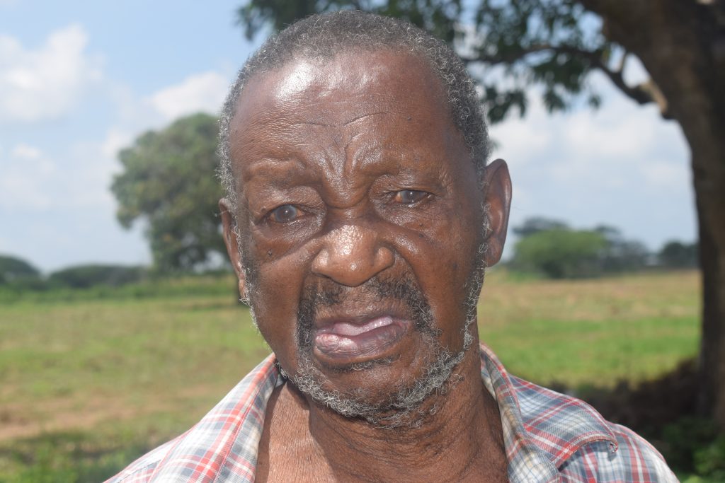A distraught Mzee Kitsao Ngoa of Kavunyalalo Village, Malindi Sub-County in Kilifi in a pensive mood. His wife Kadzu Baya was hacked to death by unknown people in July 2019.A suspect was arrested and is facing murder charge at the Malindi High Court. Mzee Ngoa fears for his life following constant threats to him too. / Photo Courtesy of Haki Yetu Org.